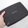Hand holding HUMAX digital device.