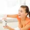 Woman playing with a white game controller.