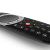 Modern black streaming TV remote control on dark background.